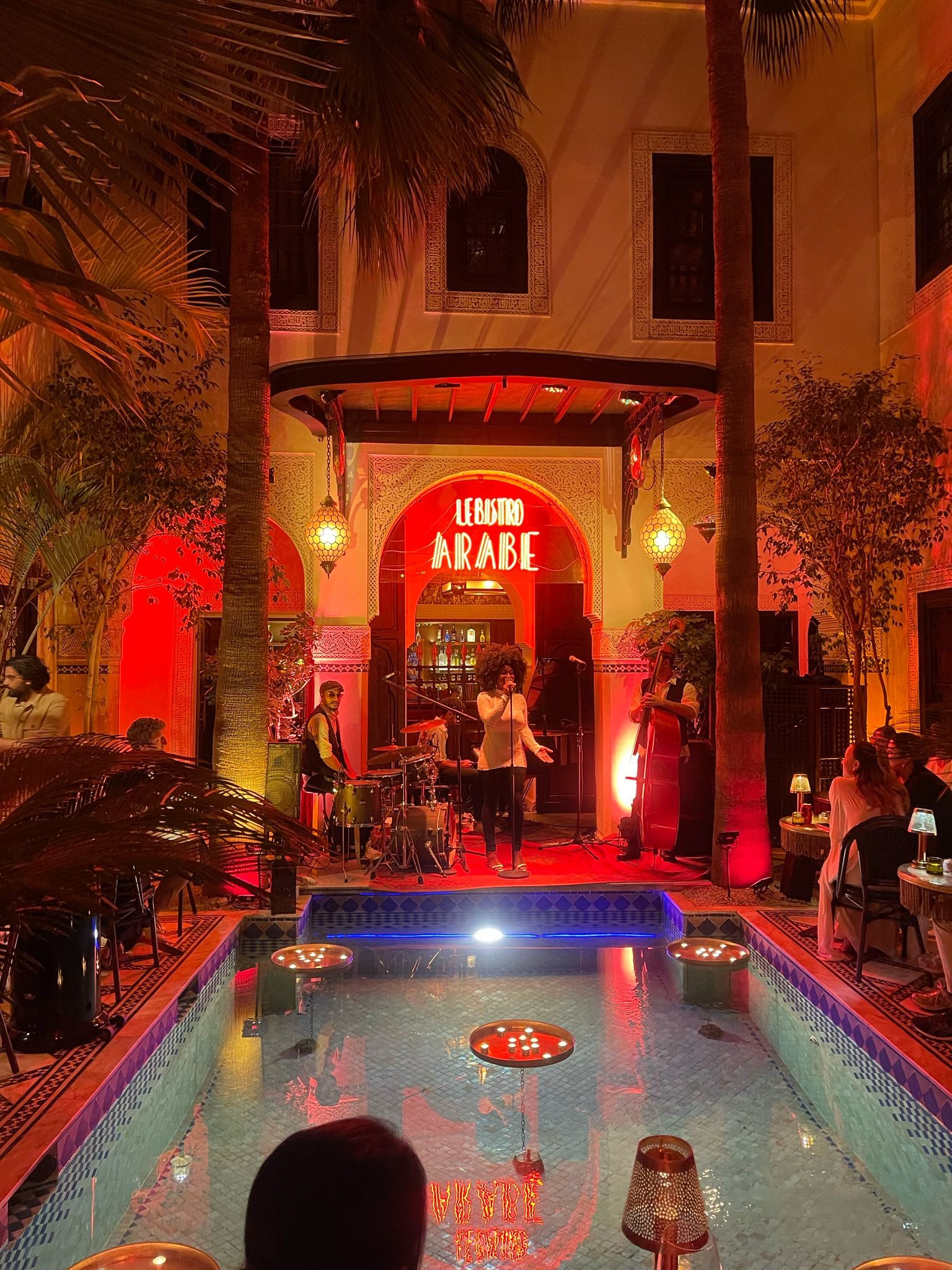 Moroccan jazz restaurant in Marrakech with live singer, band, and red ambient lighting