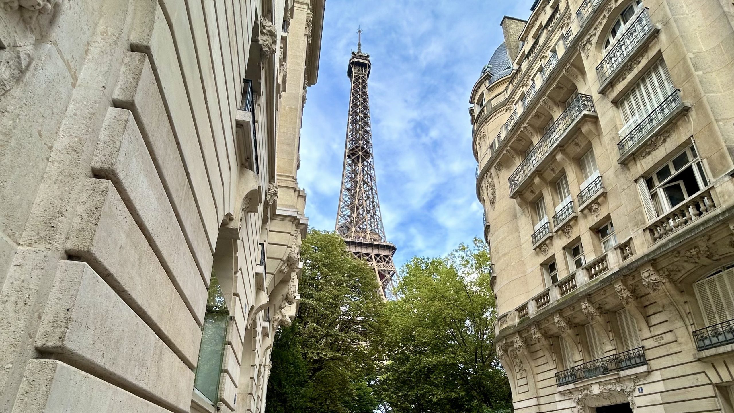 The Eiffel Tower situated between two buildings.